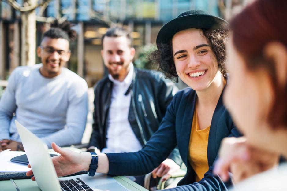 A diverse group of smiling students sitting together